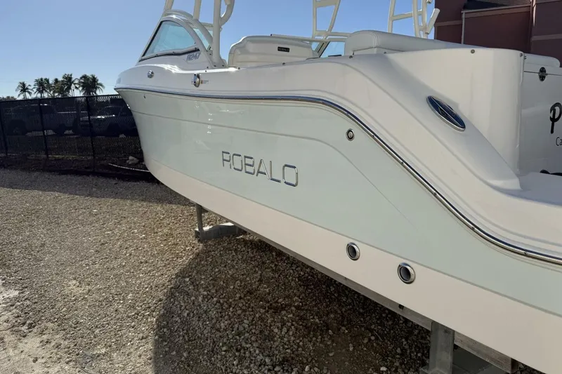 Slide: The Image of 2018 Robalo R247 Dual Console boat on display, side view. - 4