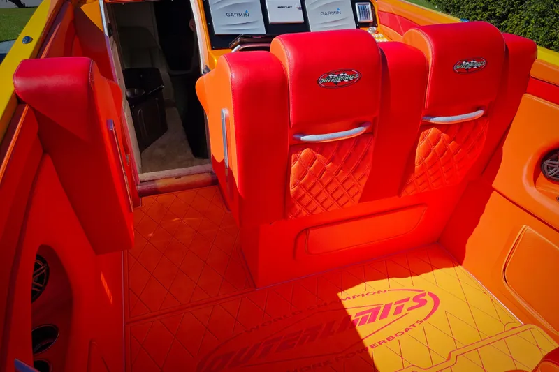 Slide: The Image of Interior of 2005 Outerlimits 51 Sport Yacht with vibrant red and orange seating. - 13
