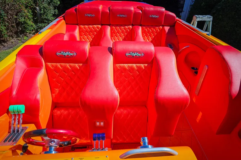 Slide: The Image of Vibrant red interior of 2005 Outerlimits 51 Sport Yacht with quilted seats and controls. - 18