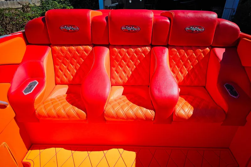 Slide: The Image of Red and orange seating on 2005 Outerlimits 51 Sport Yacht, featuring quilted design. - 19