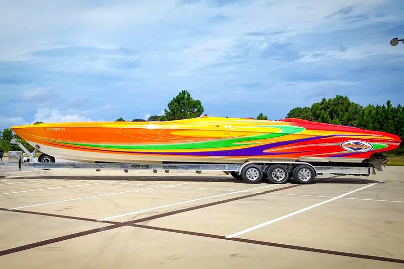 Slide: The Image of 2005 Outerlimits 51 Sport Yacht with vibrant multicolor design on a trailer. - 2