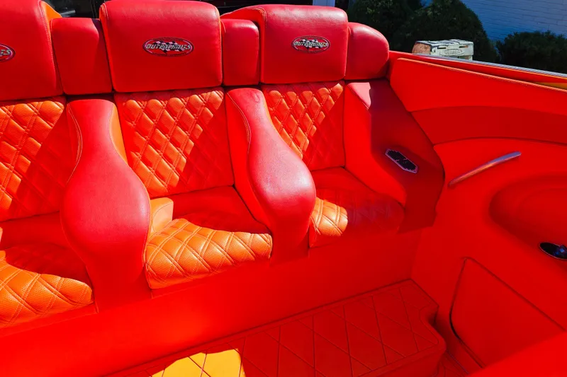 Slide: The Image of Luxurious red seating in a 2005 Outerlimits 51 Sport Yacht, featuring quilted upholstery. - 20