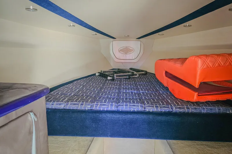 Slide: The Image of Interior cabin of 2005 Outerlimits 51 Sport Yacht with bed and orange cushions. - 25