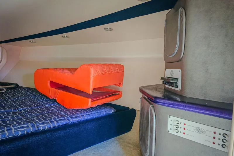 Slide: The Image of Interior of 2005 Outerlimits 51 Sport Yacht with vibrant orange seating and modern controls. - 26