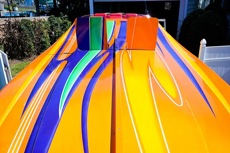 Slide: The Image of Colorful 2005 Outerlimits 51 Sport Yacht with vibrant orange, blue, and green design. - 9