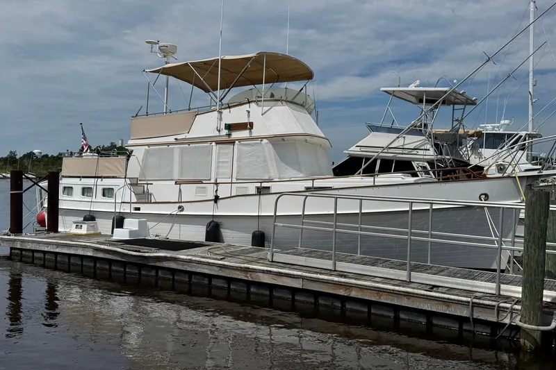 The Image of 1989 Grand Banks 42 Motor Yacht docked at marina under cloudy sky. - 1