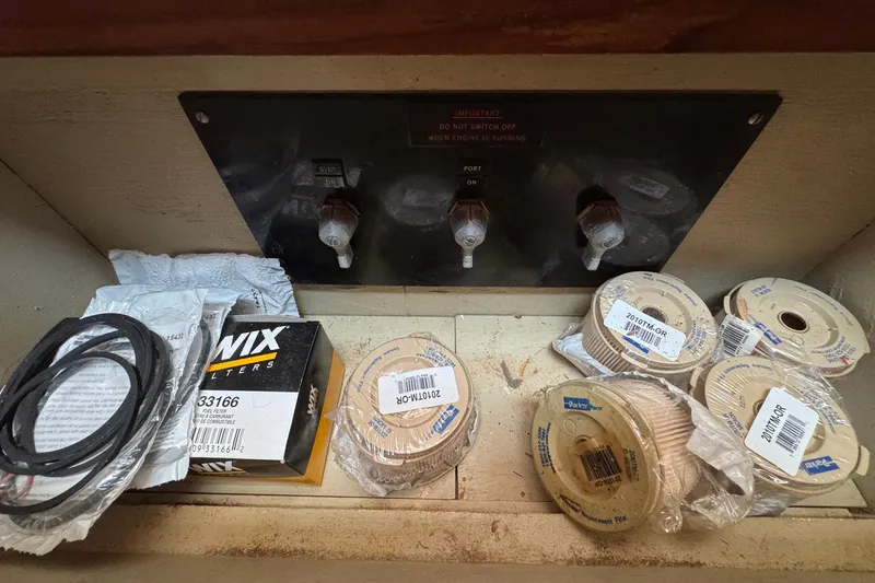 Slide: The Image of Spare parts and filters in a 1989 Grand Banks 42 Motor Yacht storage compartment. - 101
