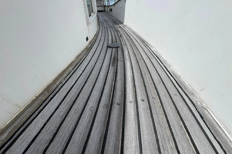 Slide: The Image of Teak deck of 1989 Grand Banks 42 Motor Yacht, showcasing elegant wood grain. - 15