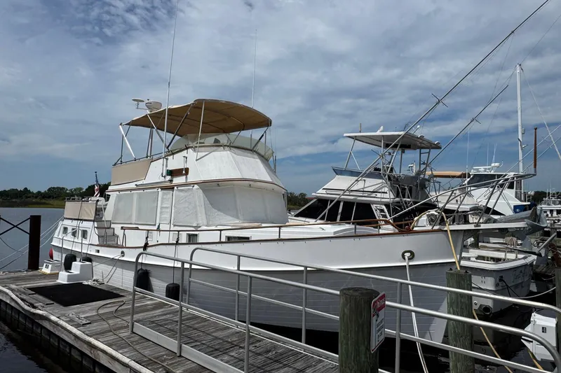 Slide: The Image of 1989 Grand Banks 42 Motor Yacht docked at marina under cloudy sky. - 2