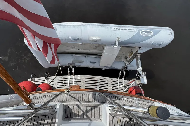 Slide: The Image of Grand Banks 42 Motor Yacht 1989 with dinghy and American flag on deck. - 23