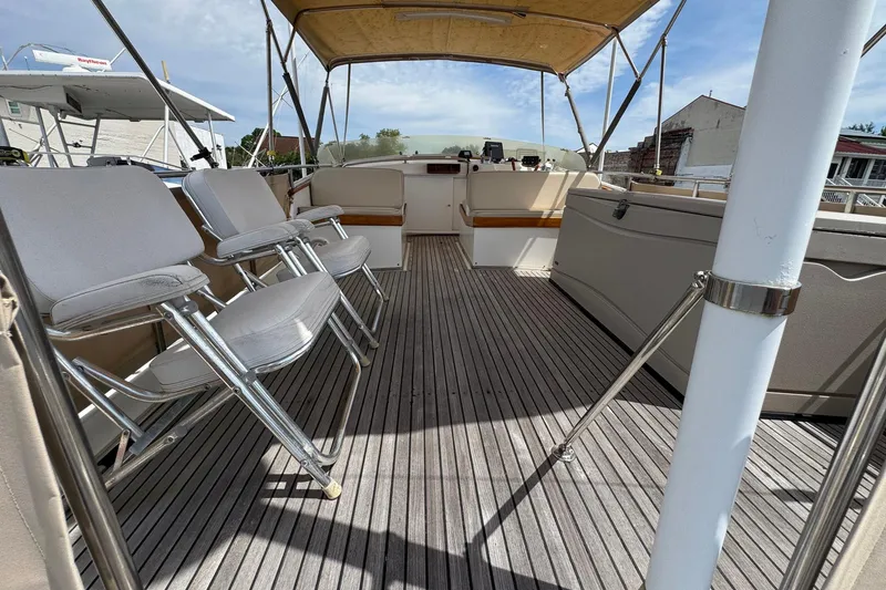 Slide: The Image of 1989 Grand Banks 42 Motor Yacht deck with seating and canopy, showcasing elegant design. - 29