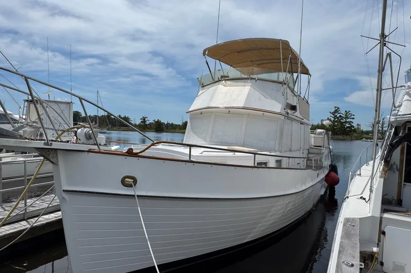 Slide: The Image of 1989 Grand Banks 42 Motor Yacht docked, featuring classic design and spacious deck. - 3