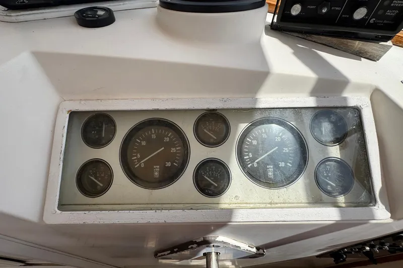 Slide: The Image of Dashboard of a 1989 Grand Banks 42 Motor Yacht with various gauges and controls. - 37