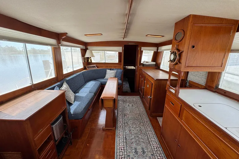 Slide: The Image of Interior of 1989 Grand Banks 42 Motor Yacht with wooden furnishings and blue seating. - 39