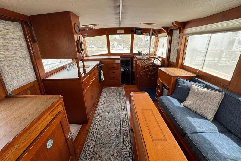 Slide: The Image of Interior of 1989 Grand Banks 42 Motor Yacht with wooden furnishings and cozy seating. - 41