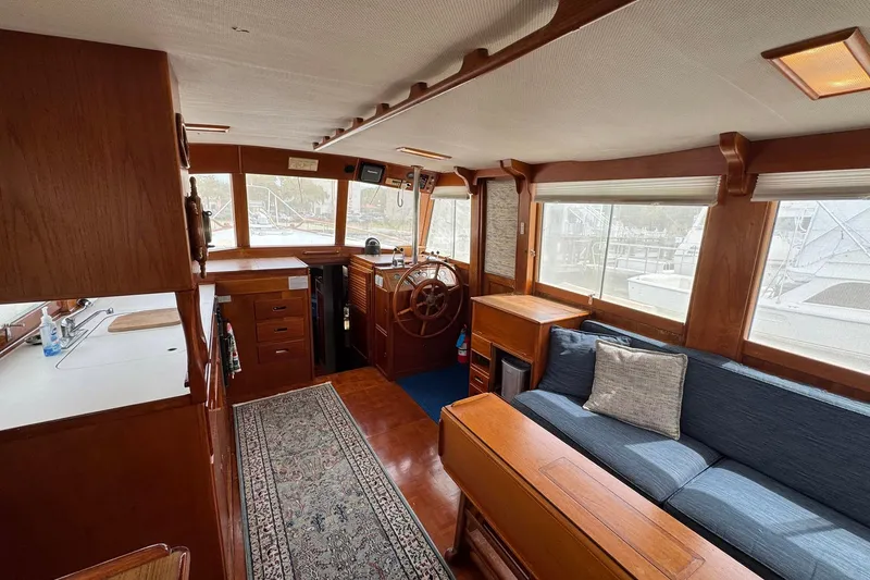 Slide: The Image of Interior of 1989 Grand Banks 42 Motor Yacht with wooden furnishings and cozy seating. - 44