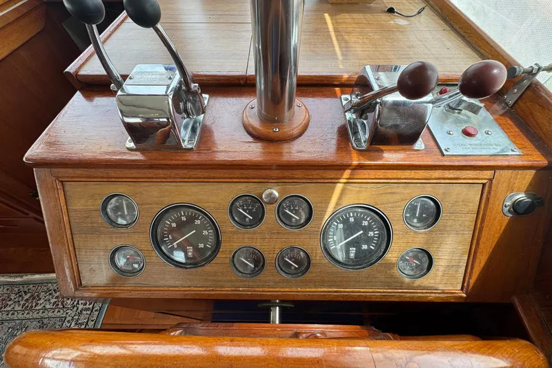 Slide: The Image of Control panel of a 1989 Grand Banks 42 Motor Yacht with gauges and levers. - 45