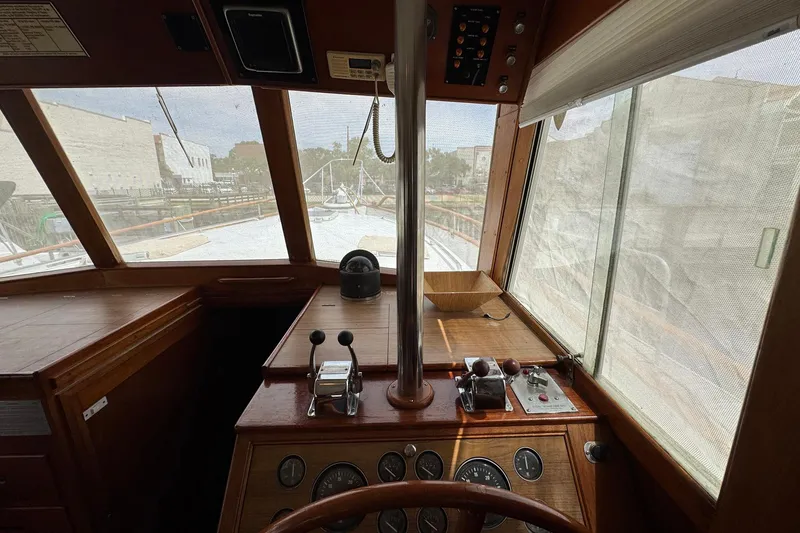 Slide: The Image of Interior helm of 1989 Grand Banks 42 Motor Yacht with wooden dashboard and controls. - 46