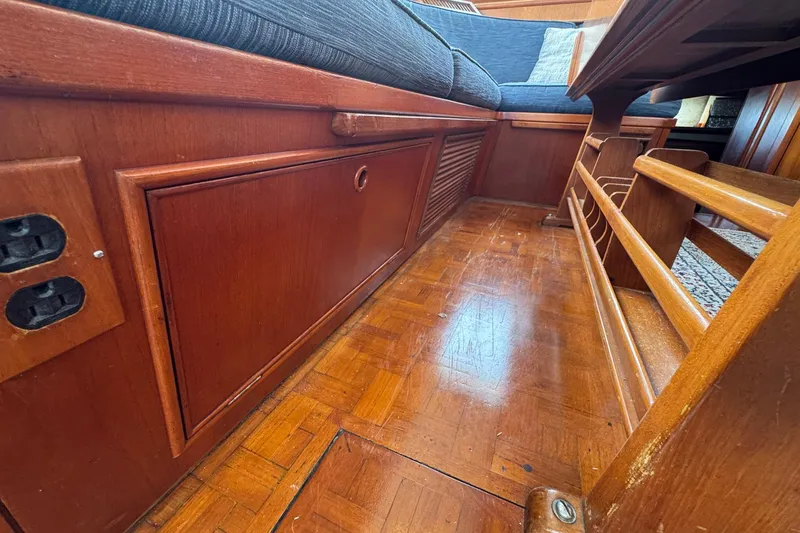 Slide: The Image of Interior of 1989 Grand Banks 42 Motor Yacht with wooden flooring and seating. - 50
