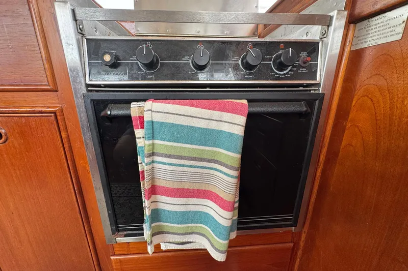 Slide: The Image of Oven with striped towel in 1989 Grand Banks 42 Motor Yacht kitchen. - 54
