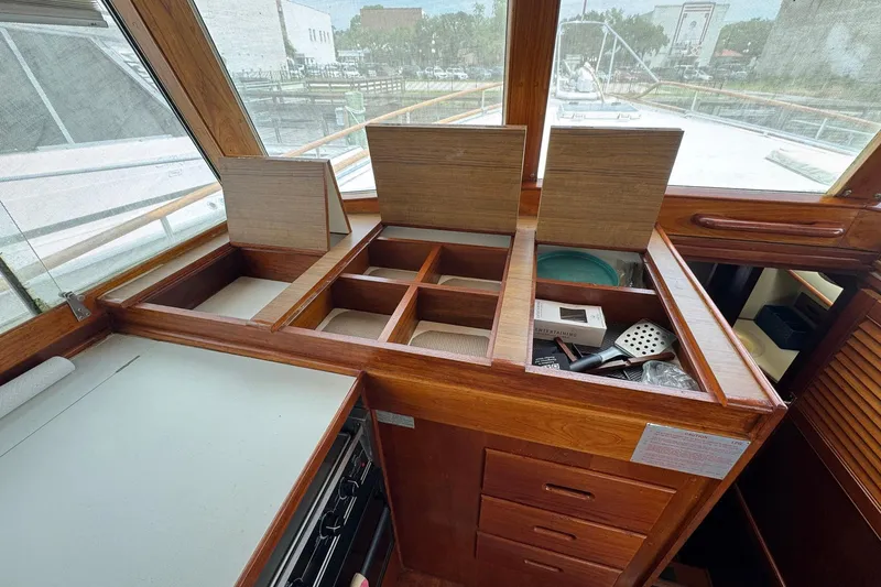 Slide: The Image of Interior of 1989 Grand Banks 42 Motor Yacht with wooden storage compartments. - 56
