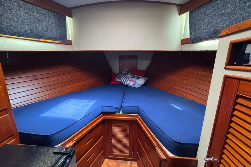 Slide: The Image of Cozy cabin interior of 1989 Grand Banks 42 Motor Yacht with blue bedding. - 57