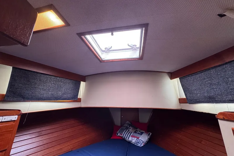 Slide: The Image of Cozy cabin interior of 1989 Grand Banks 42 Motor Yacht with skylight and cushions. - 60