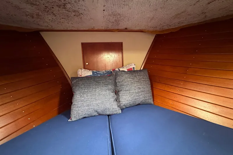 Slide: The Image of Cozy cabin interior of 1989 Grand Banks 42 Motor Yacht with wooden paneling and cushions. - 61