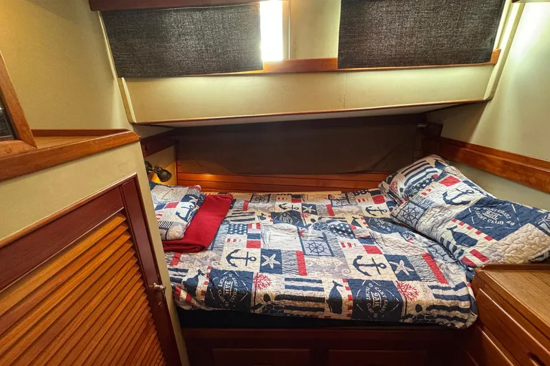Slide: The Image of Cozy cabin interior of 1989 Grand Banks 42 Motor Yacht with nautical-themed bedding. - 63