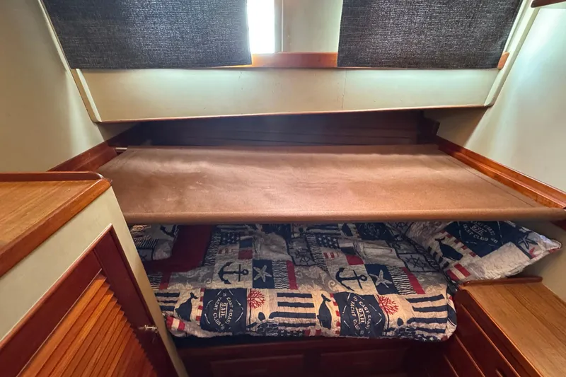 Slide: The Image of Cozy cabin interior of 1989 Grand Banks 42 Motor Yacht with nautical-themed bedding. - 66