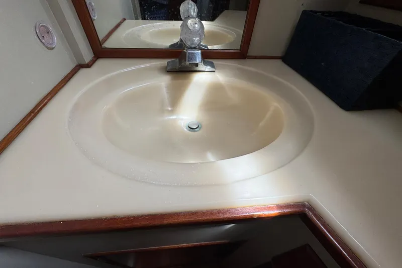 Slide: The Image of Bathroom sink in 1989 Grand Banks 42 Motor Yacht with wooden trim and mirror. - 68