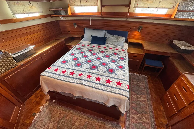 Slide: The Image of Cozy bedroom in 1989 Grand Banks 42 Motor Yacht with quilted bedspread and wooden furnishings. - 70