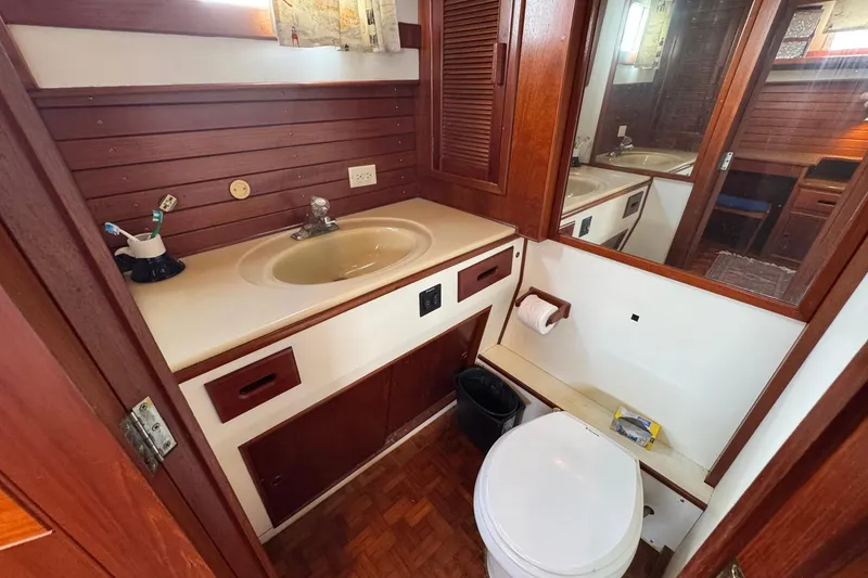 Slide: The Image of 1989 Grand Banks 42 Motor Yacht bathroom with wooden cabinetry and sink. - 77