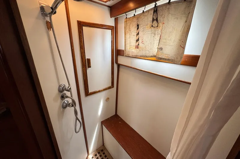 Slide: The Image of Shower area in 1989 Grand Banks 42 Motor Yacht with wooden accents and nautical decor. - 78