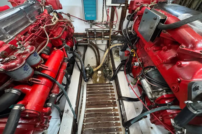Slide: The Image of Engine room of 1989 Grand Banks 42 Motor Yacht with red machinery and wiring. - 81