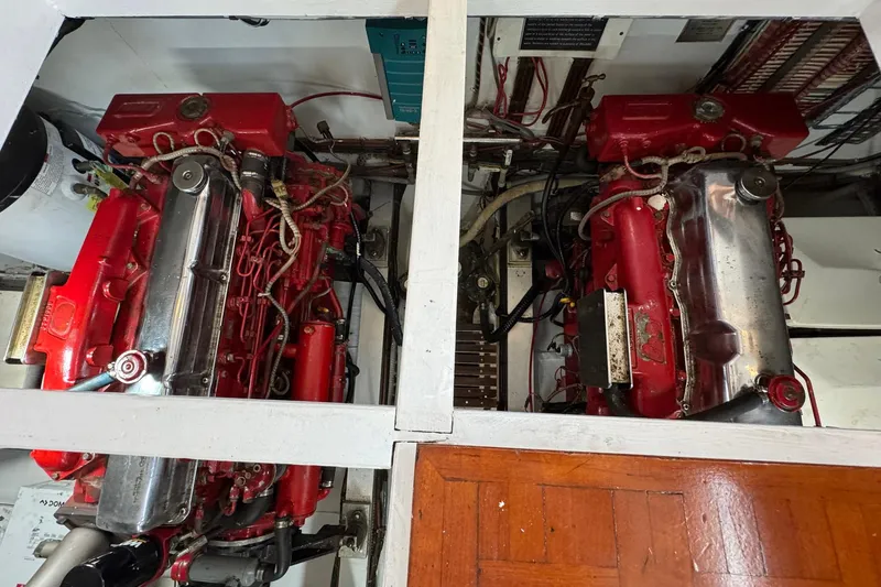 Slide: The Image of Engine room of 1989 Grand Banks 42 Motor Yacht with twin red engines. - 82