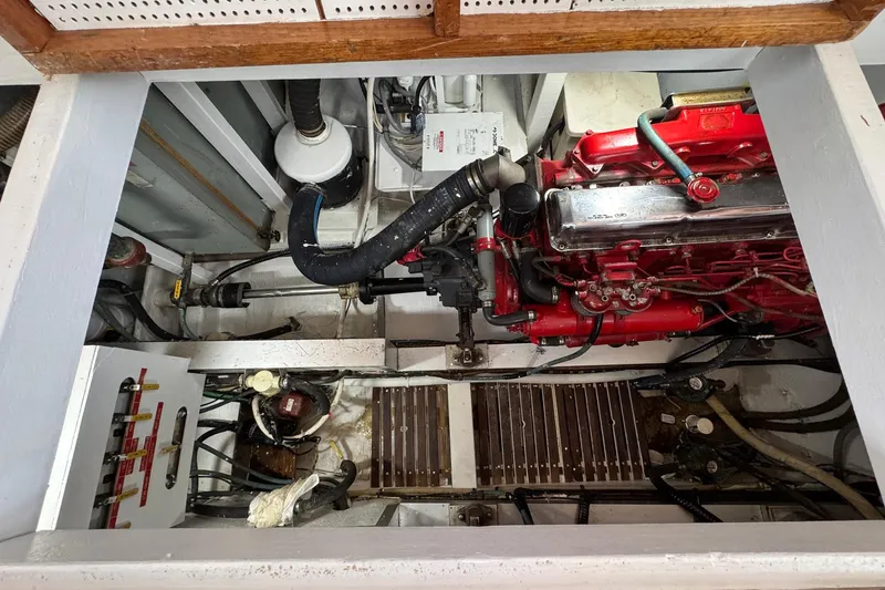 Slide: The Image of Engine room of 1989 Grand Banks 42 Motor Yacht with visible red engine components. - 83