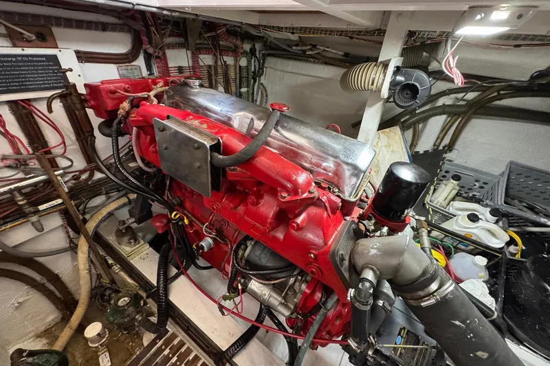 Slide: The Image of Engine room of a 1989 Grand Banks 42 Motor Yacht, featuring a red engine. - 84