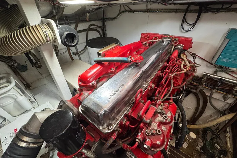 Slide: The Image of Engine room of 1989 Grand Banks 42 Motor Yacht with red engine components. - 85