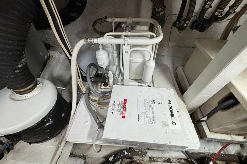 Slide: The Image of Engine room of 1989 Grand Banks 42 Motor Yacht with mechanical components. - 86