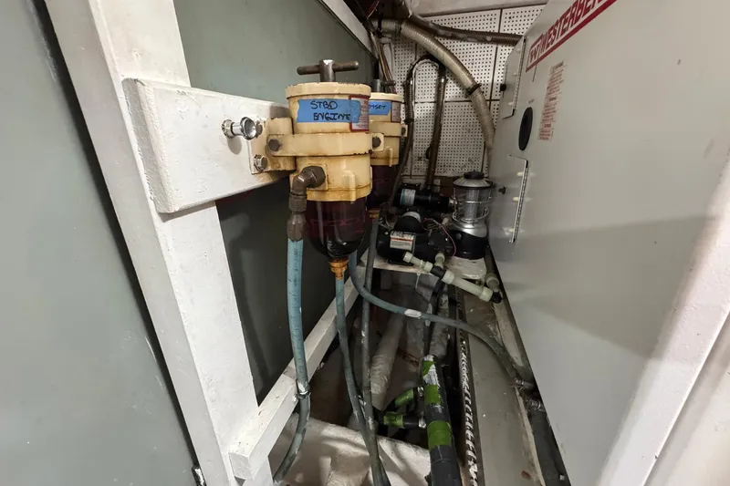 Slide: The Image of Engine room of 1989 Grand Banks 42 Motor Yacht with fuel filters and hoses. - 88