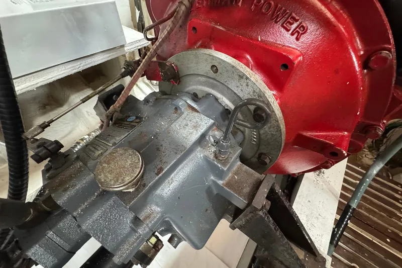 Slide: The Image of Engine component of 1989 Grand Banks 42 Motor Yacht, featuring red and gray machinery. - 90