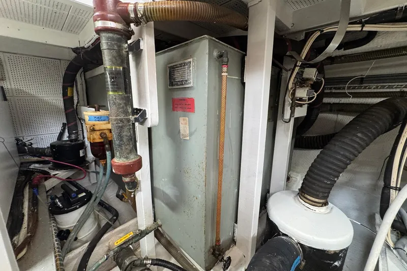 Slide: The Image of Engine room of 1989 Grand Banks 42 Motor Yacht with utility pump and piping. - 92
