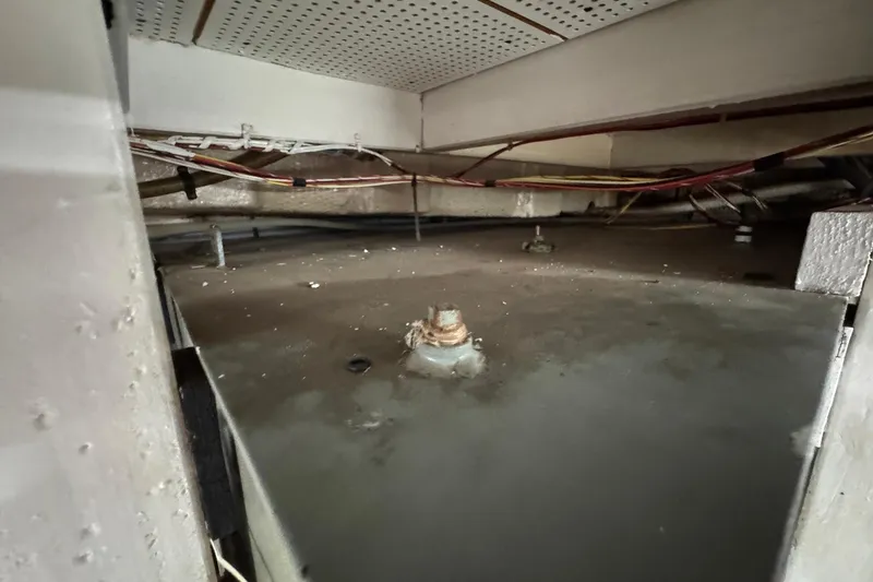 Slide: The Image of Bilge area of a 1989 Grand Banks 42 Motor Yacht, showing wiring and structural components. - 93