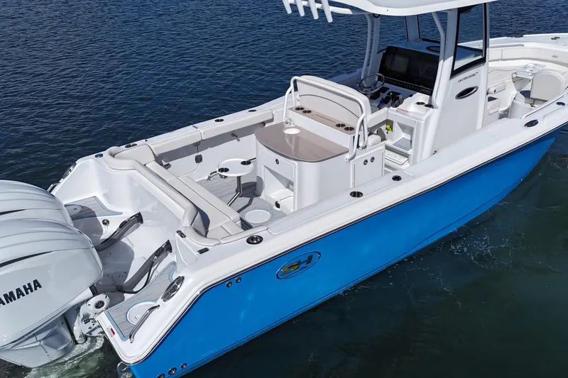 Slide: The Image of 2023 Sea Hunt Ultra 305 SE boat on water, featuring sleek design and dual engines. - 13