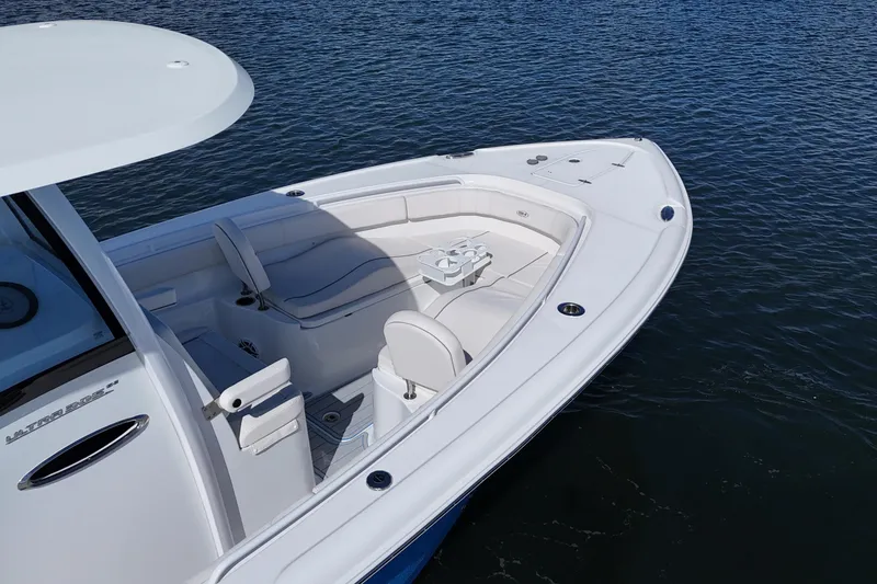 Slide: The Image of 2023 Sea Hunt Ultra 305 SE boat on water, featuring spacious seating and sleek design. - 14