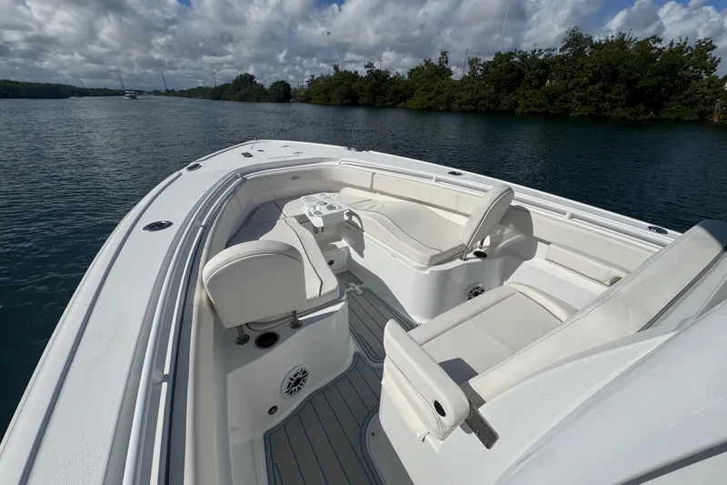 Slide: The Image of 2023 Sea Hunt Ultra 305 SE boat interior with white seating and open water view. - 19