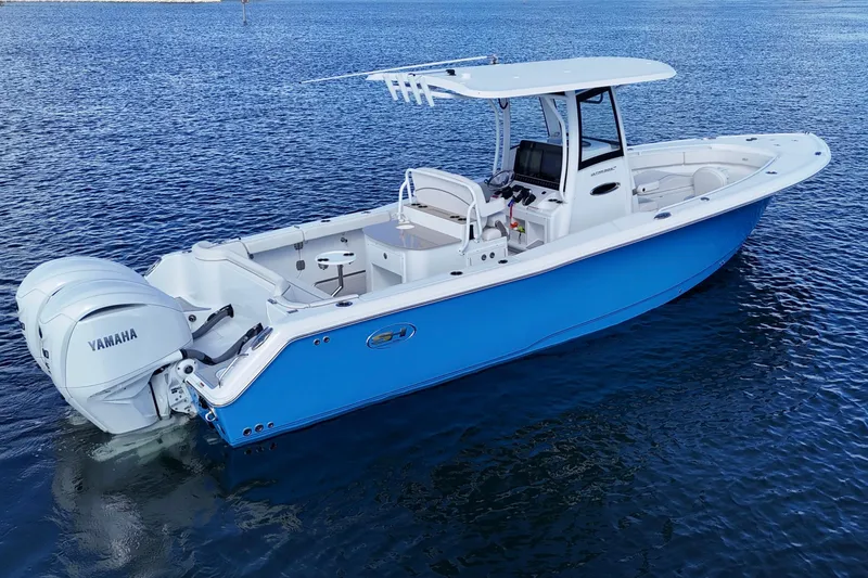 Slide: The Image of 2023 Sea Hunt Ultra 305 SE boat on water, featuring Yamaha engines. - 6