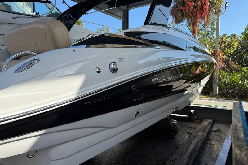 Slide: The Image of 2018 Crownline Eclipse E24 XS boat with Yamaha VMAX 250 engine, docked under shelter. - 11