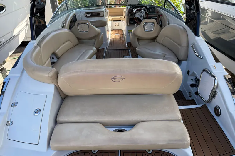 Slide: The Image of 2018 Crownline Eclipse E24 XS boat deck with wood finish and beige seating. - 17